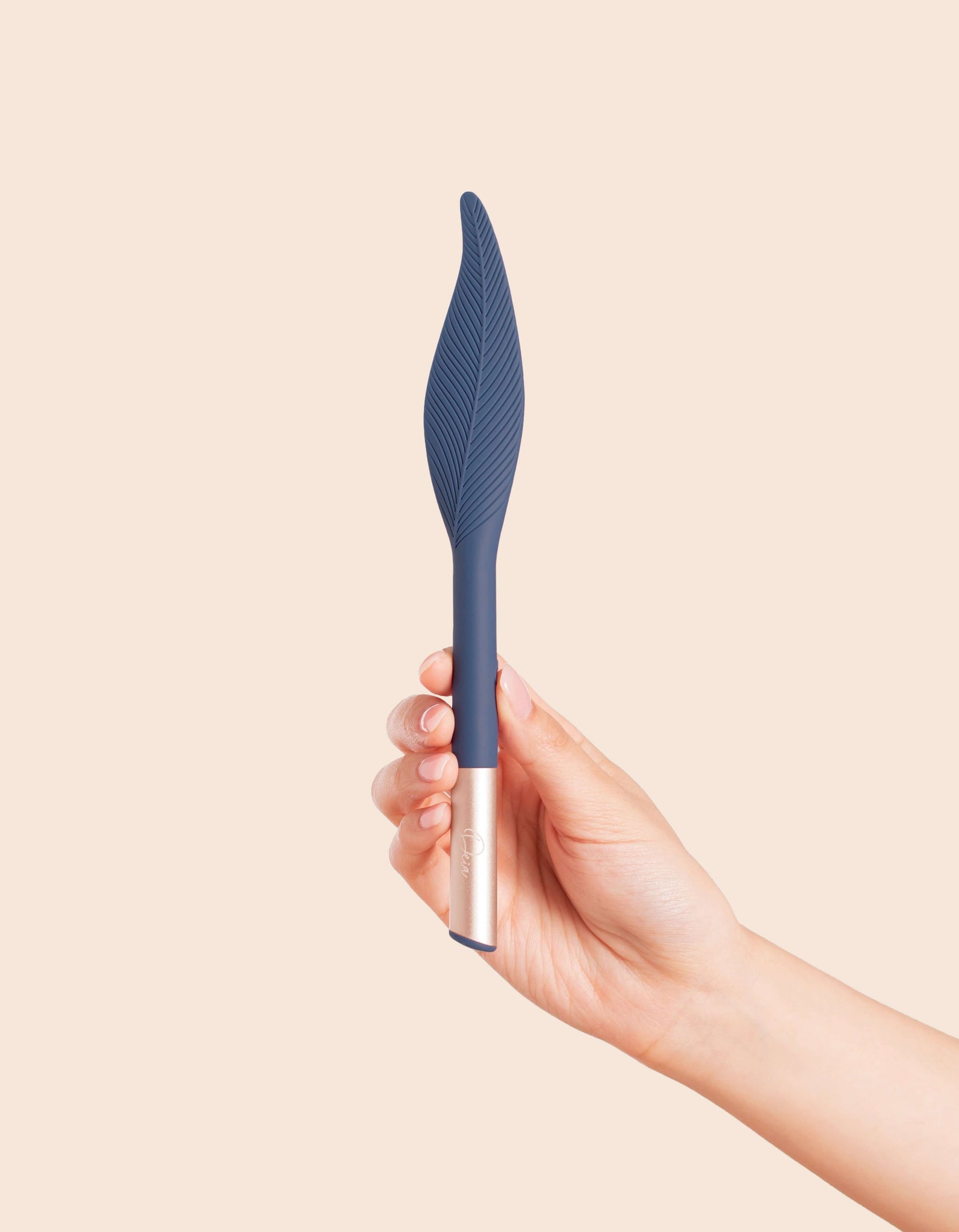 The Feather by Die Periwinkle Blue being held in vertical position by female hand
