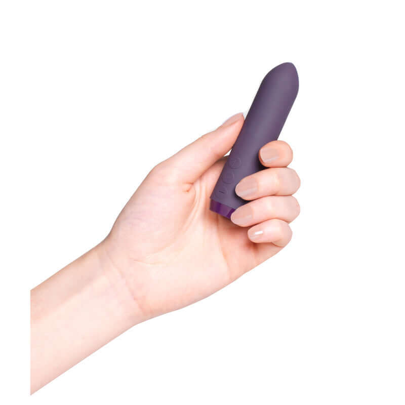 Hand holding purple Je Joue Classic Bullet Vibrator from Tickle-Boxx, showcasing pocket-size elegance and powerful functionality.